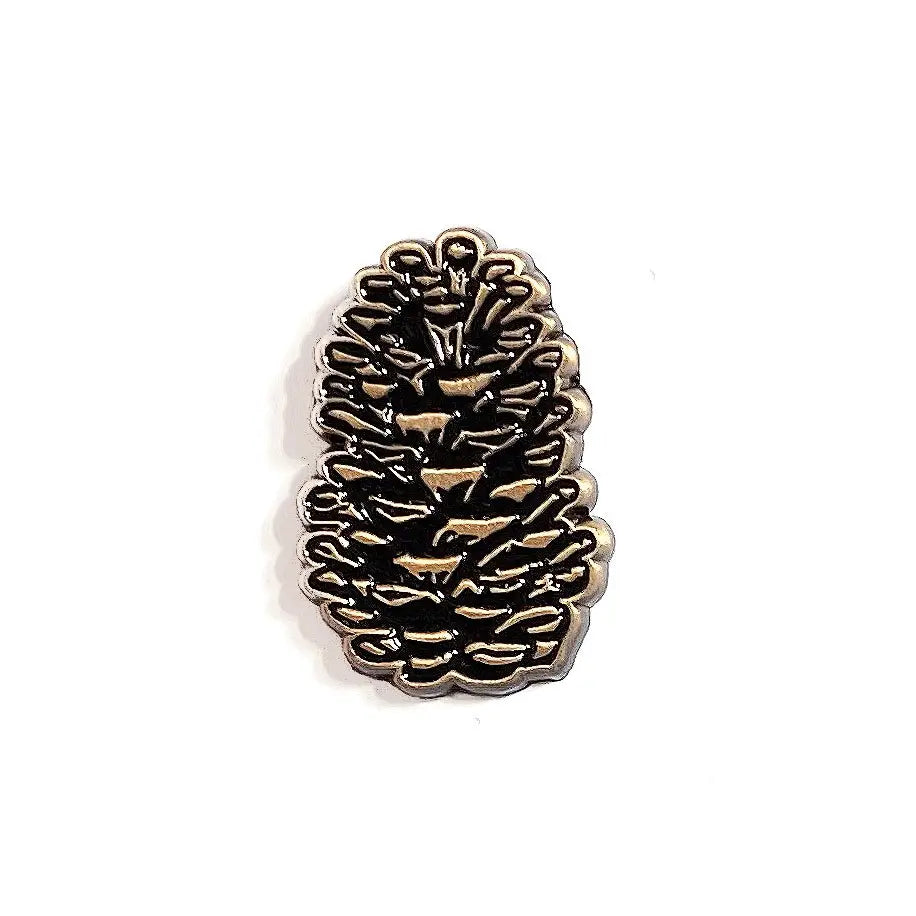 The Wild Wander Pine Cone Enamel Pin on white background; nature-inspired accessory, perfect for outdoor lovers and pin collectors.