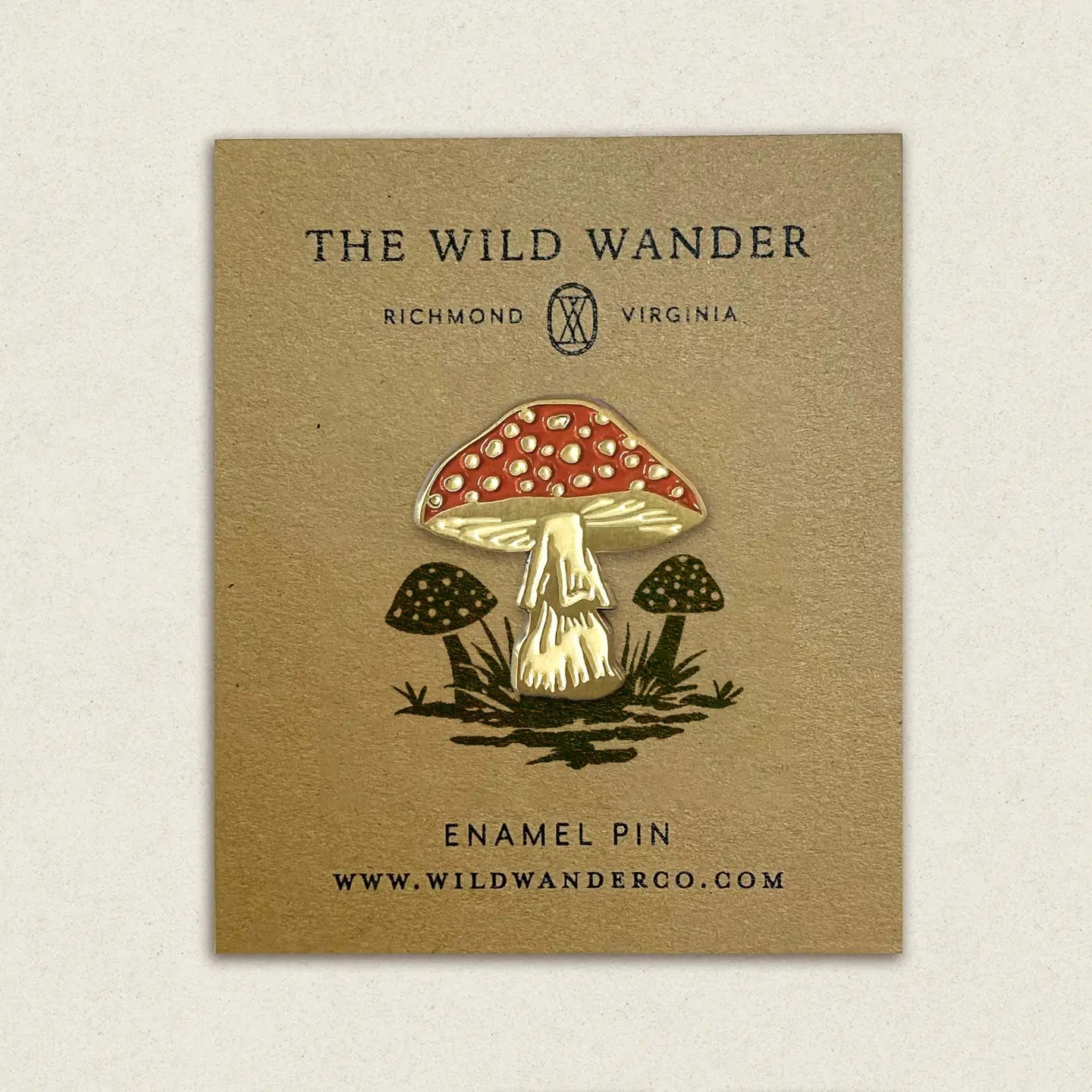 The Wild Wander Red Cap Mushroom Enamel Pin for collectors, shown on branded brown card, unique gift for mushroom lovers.