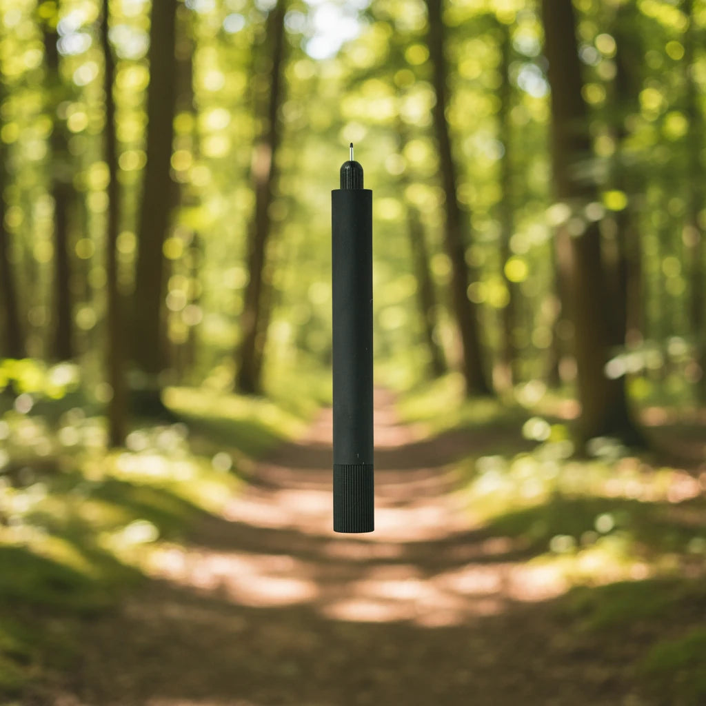 Tom’s Studio Lumos Mini Pen Matte Black, featuring a knurled grip, stands upright on a clean white background for modern style.
