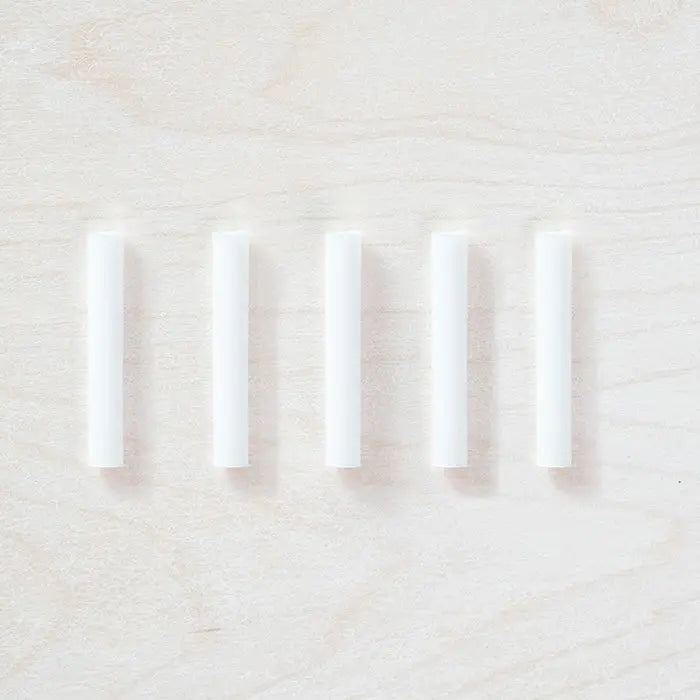 Ink refills arranged in a row on table