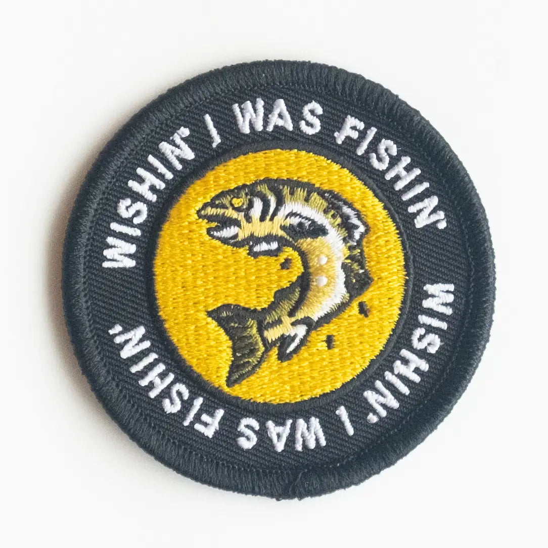 Union Made Iron On Patch—Round badge with fish and "Wishing I was Fishing" text, perfect for fishing or outdoor enthusiasts.