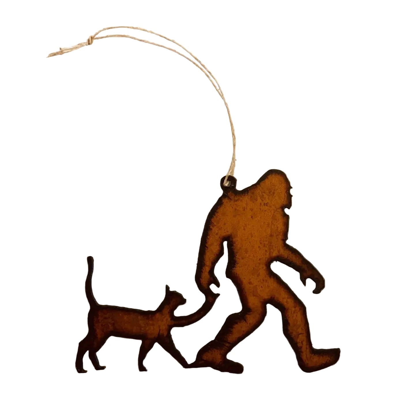 Decorative metal cutout of a bigfoot and a cat on a white background