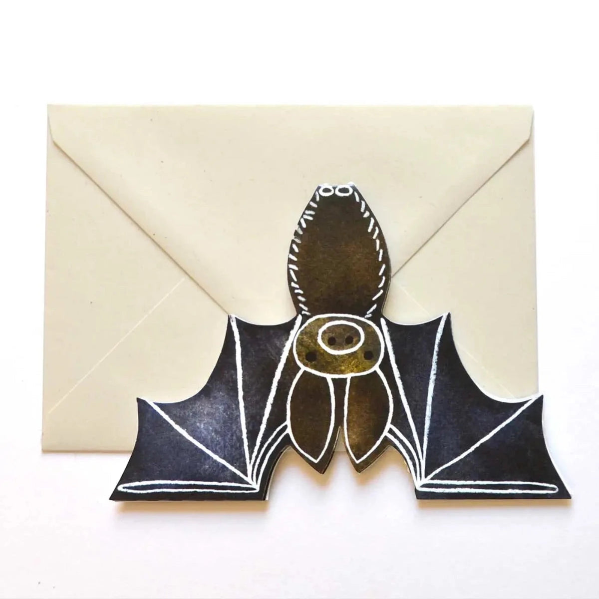 Image shows a illustrated bat greeting card laying on a off white coloured envelope