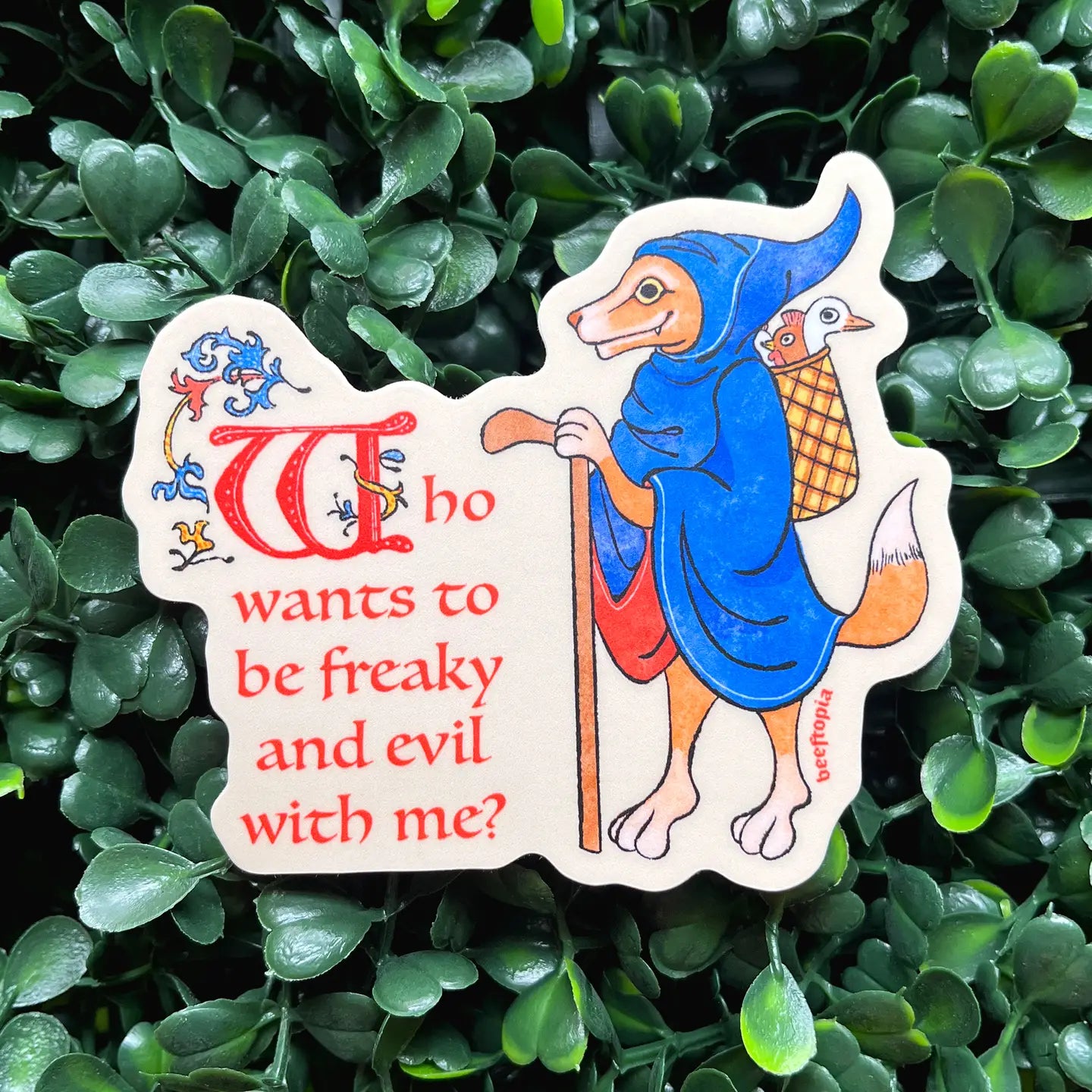 Beeftopia Who Wants To Be Freaky and Evil With Me? waterproof vinyl laptop sticker—humorous dog in blue robe, durable, fun.