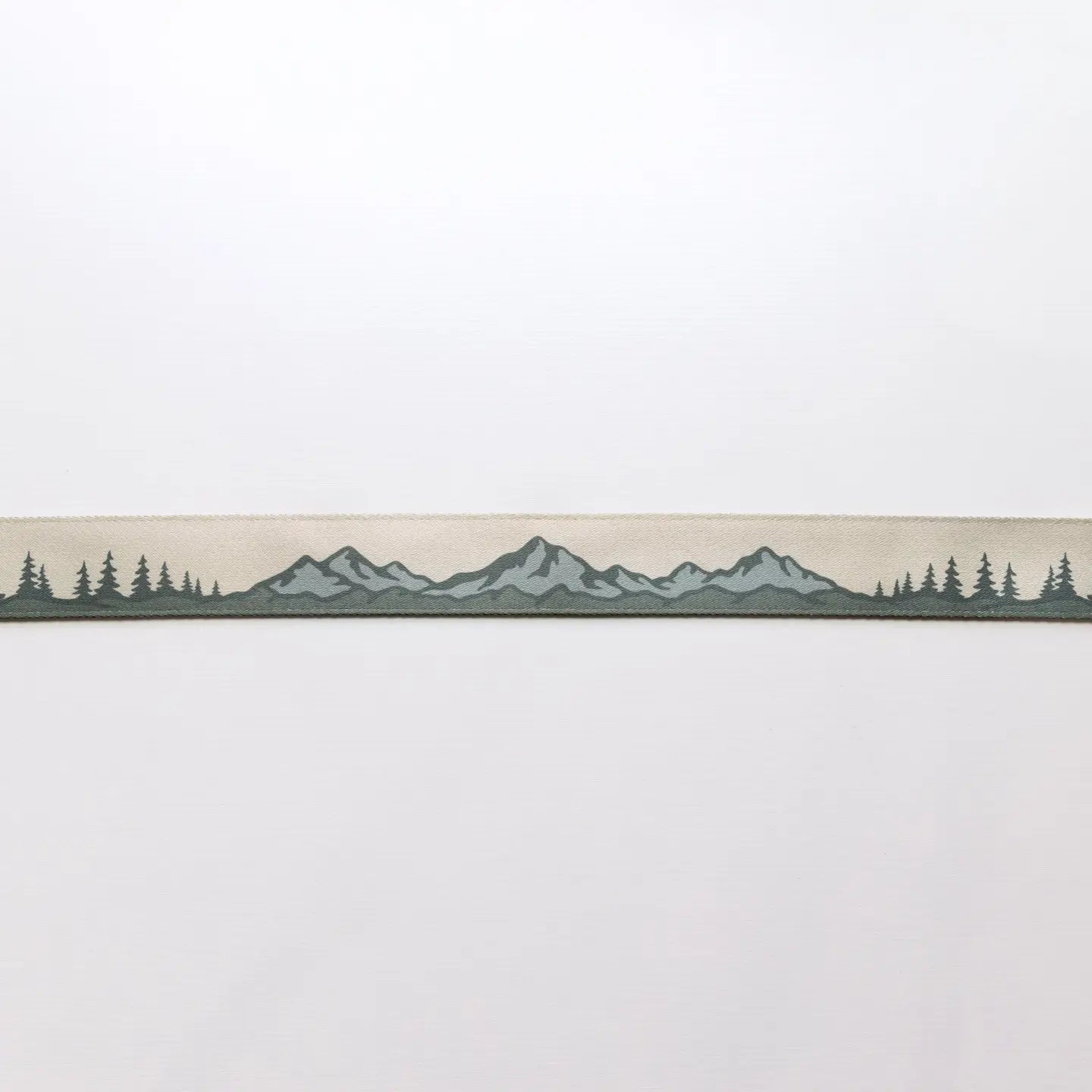 The Wildtree Landscape Camera Strap displays mountain and tree graphics on a light backdrop—nature-inspired accessory for photographers.