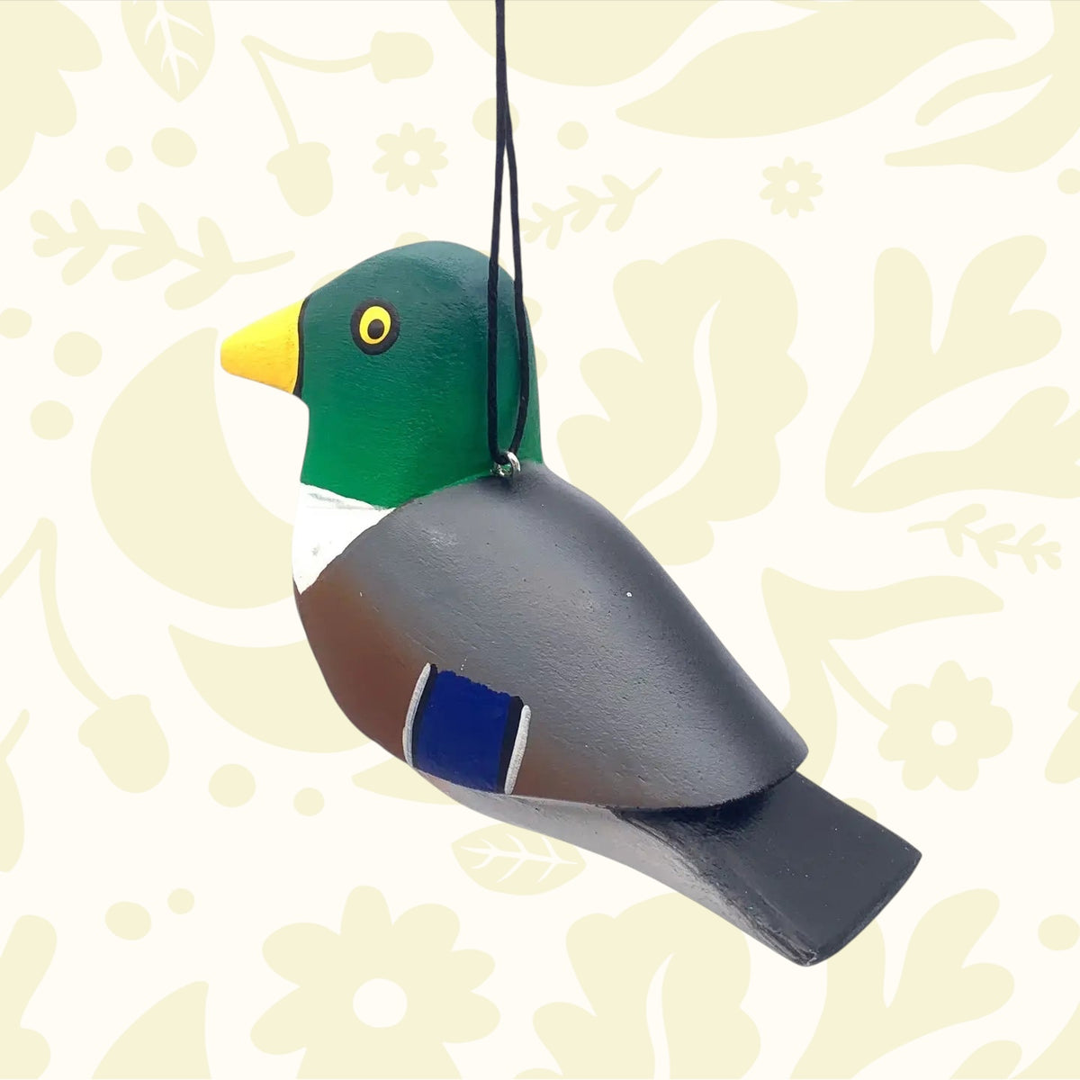 Handmade balsa wood mallard hanging ornament by Women of the Cloud Forest, painted green, yellow, brown, and blue. Unique décor.