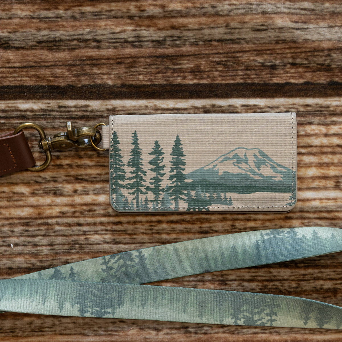 Forager Provisions LTD Wildtree National Parks card holder with matching forest print lanyard on a wooden surface.