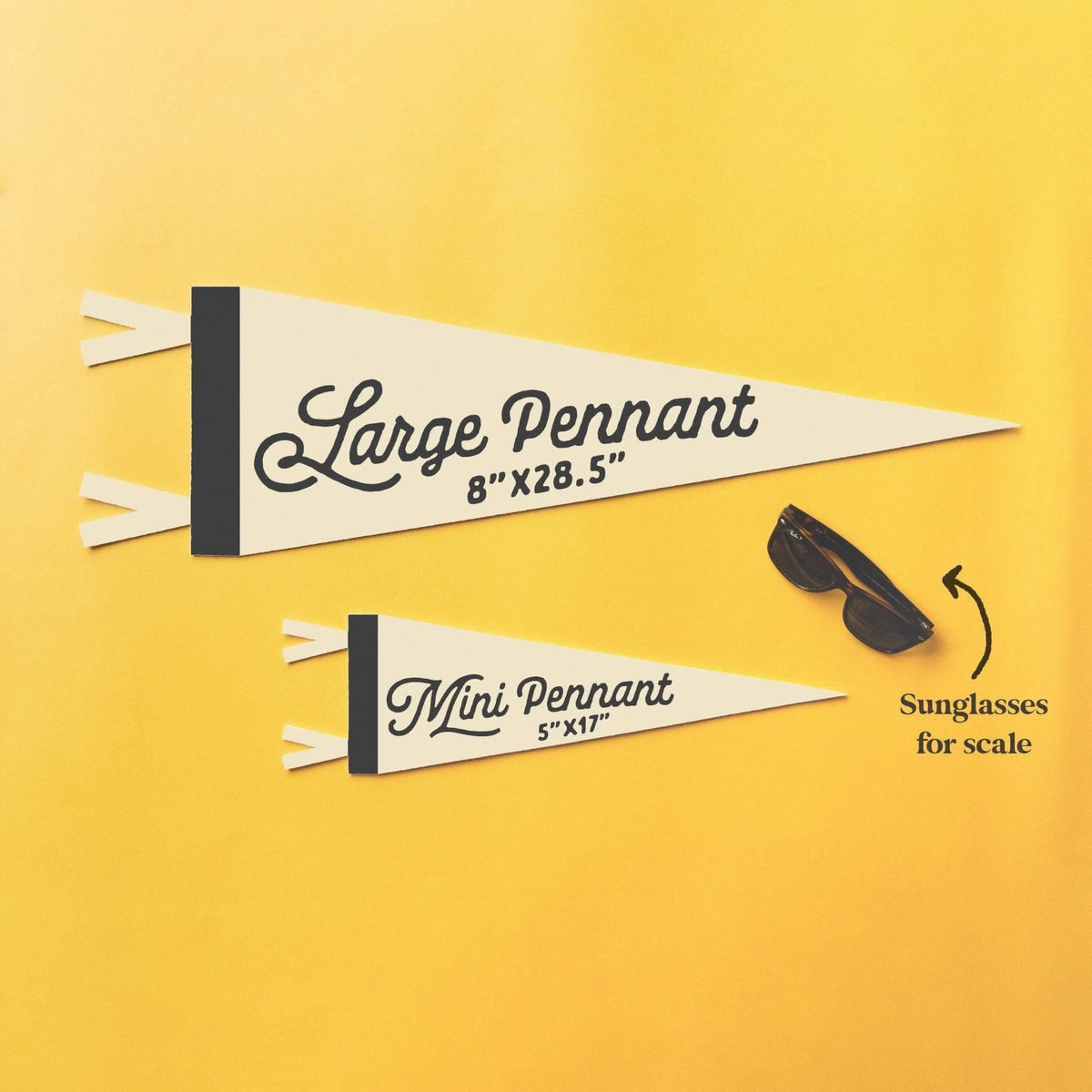 Forager Provisions LTD felt pennants in mini and large sizes displayed on a yellow background with sunglasses for scale.