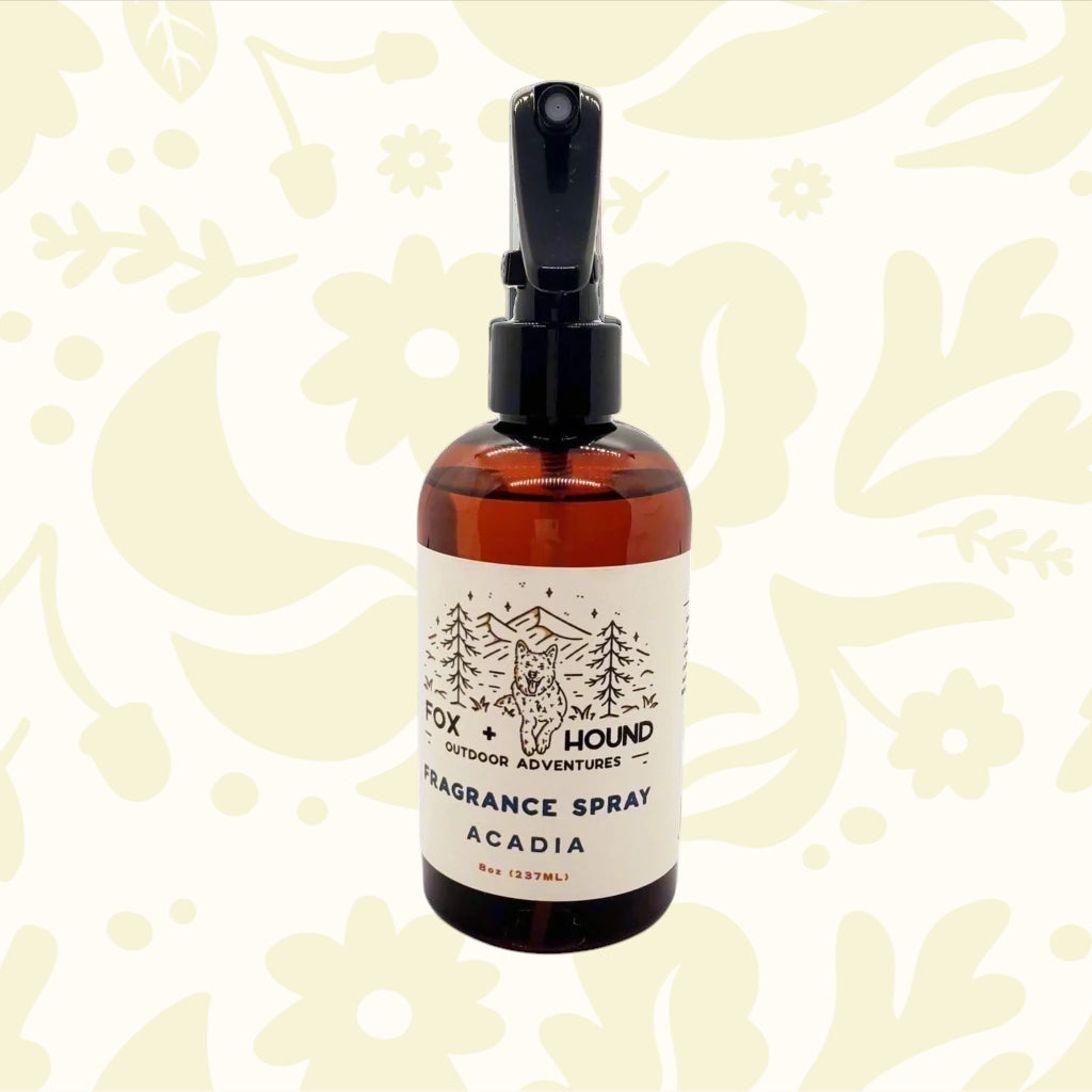 Forager Provisions LTD Fox + Hound Acadia dog cologne in an 8oz amber spray bottle against a festive holiday background.