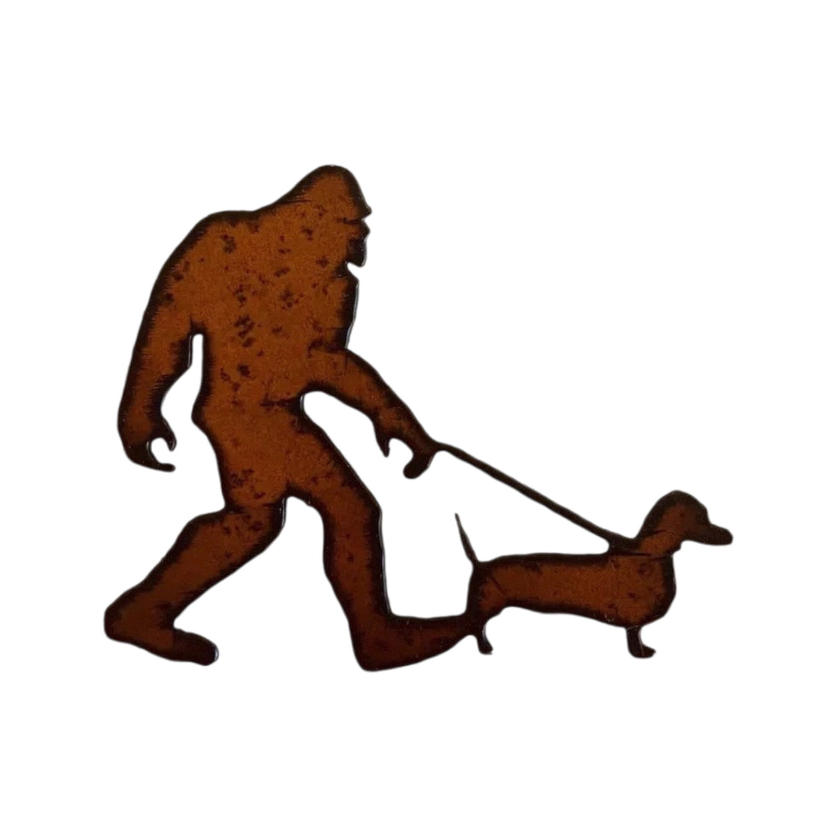 Forager Provisions LTD rustic steel magnet featuring Bigfoot walking a sausage dog, perfect for woodland decor.