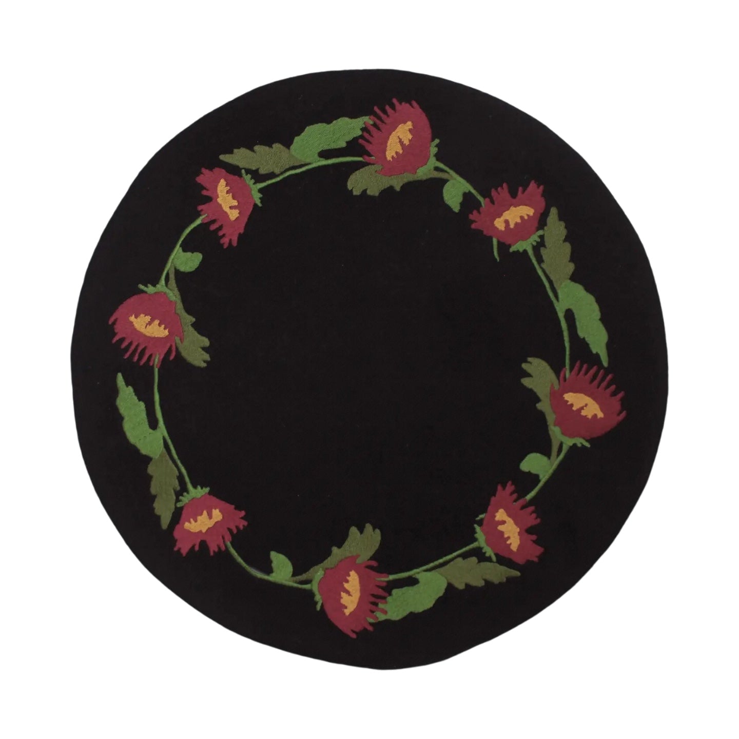 Forager Provisions LTD round black wool felt candle mat featuring a primitive folk floral wreath design.