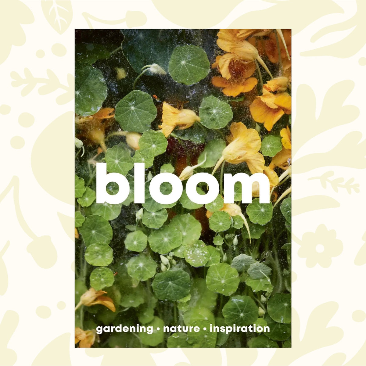 Close-up of green leaves and yellow flowers with the word "Bloom Zine Issue 15 Autumn/Winter 2023" written in bold white text. Below, it says "zero-waste garden • nature • inspiration".