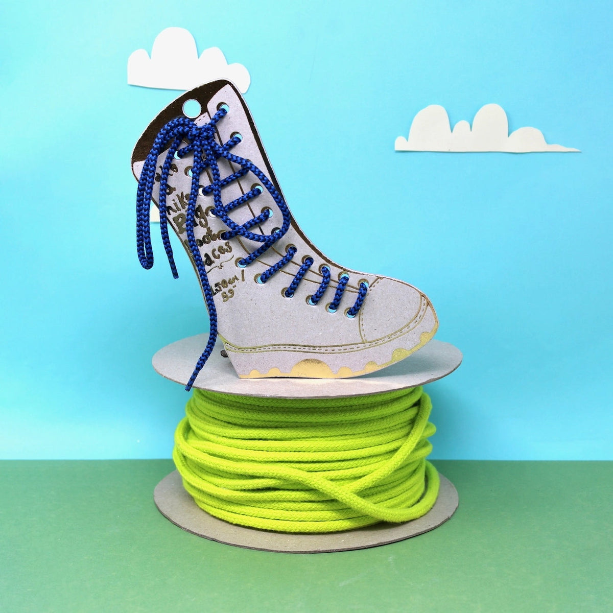 Forager Provisions LTD Ark Colour Design blue boot laces threaded through a cardboard boot cutout on a lime spool
