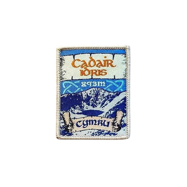 Forager Provisions LTD Cadair Idris embroidered patch featuring a mountain landscape and Welsh text on a wooden surface.
