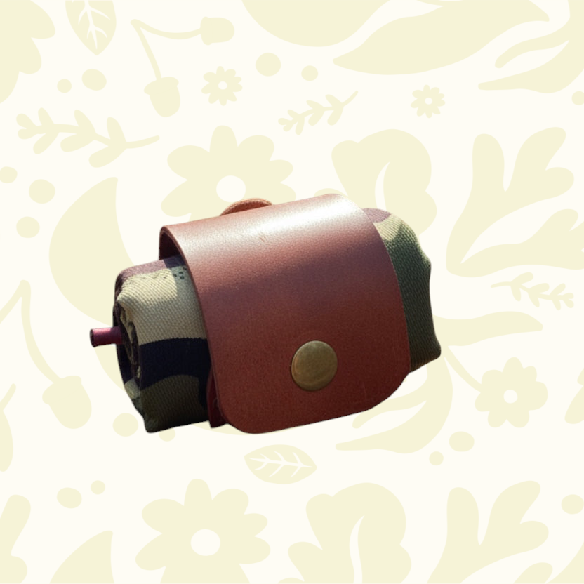 Forager Provisions LTD Kjøtt Supply Co camo forage pouch with a brown leather wrap and brass popper closure.