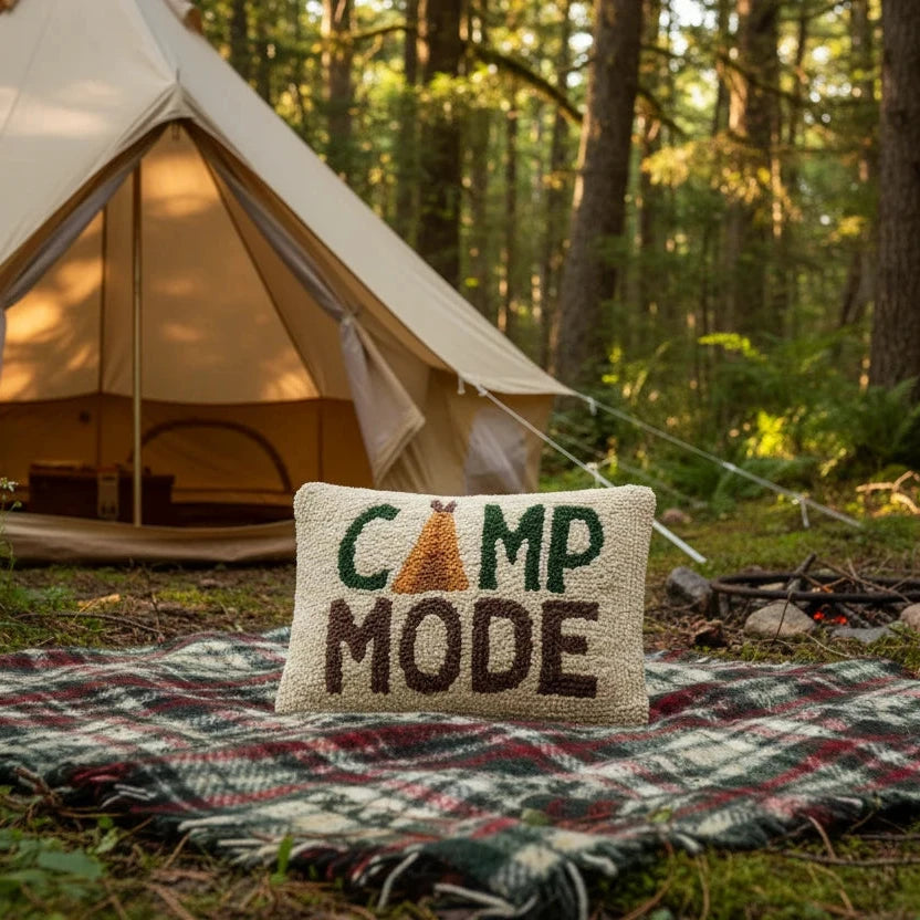 Forager Provisions LTD Peking Handicraft Camp Mode wool hooked cushion on a plaid blanket in front of a canvas tent
