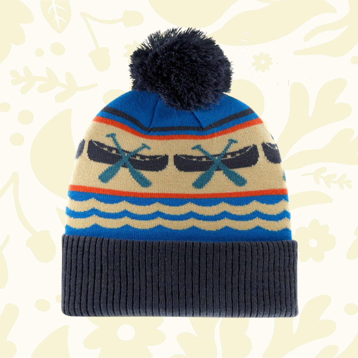 Forager Provisions LTD knit beanie with blue and cream canoe and paddle pattern, ribbed cuff, and dark blue pom pom.