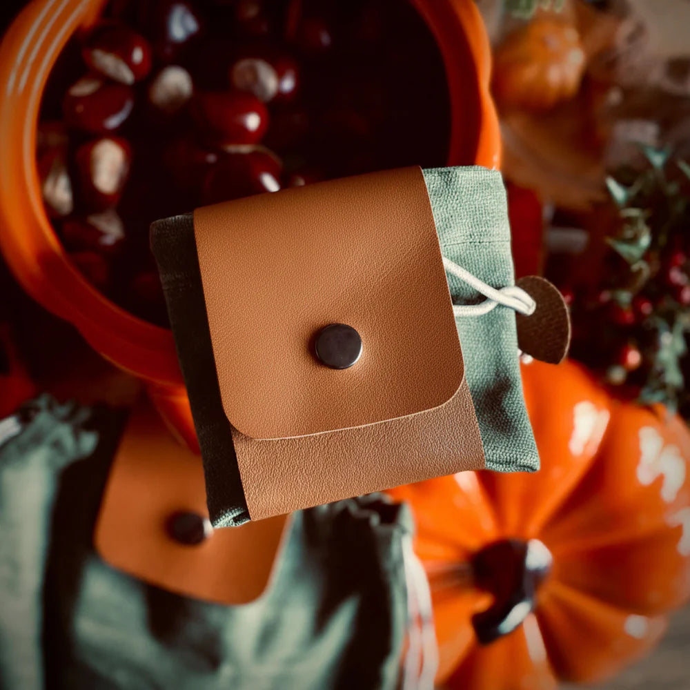 Forager Provisions LTD canvas forage bag folded into a compact pouch with vegan leather detailing and popper closure