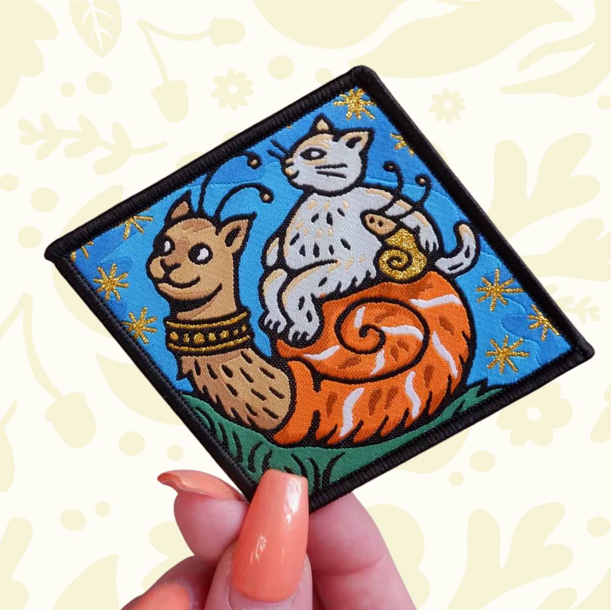 Forager Provisions LTD Cat Coven woven patch featuring a cat riding a snail in a whimsical gothic art style.