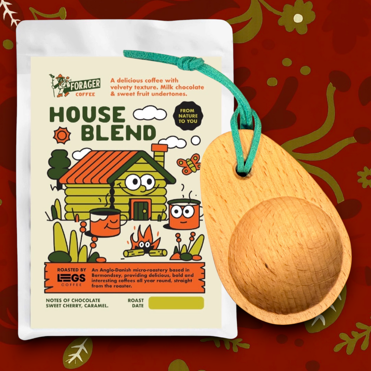 Forager Provisions LTD coffee gift set featuring a bag of Legs Coffee and a beech wood camping scoop with a green tie.