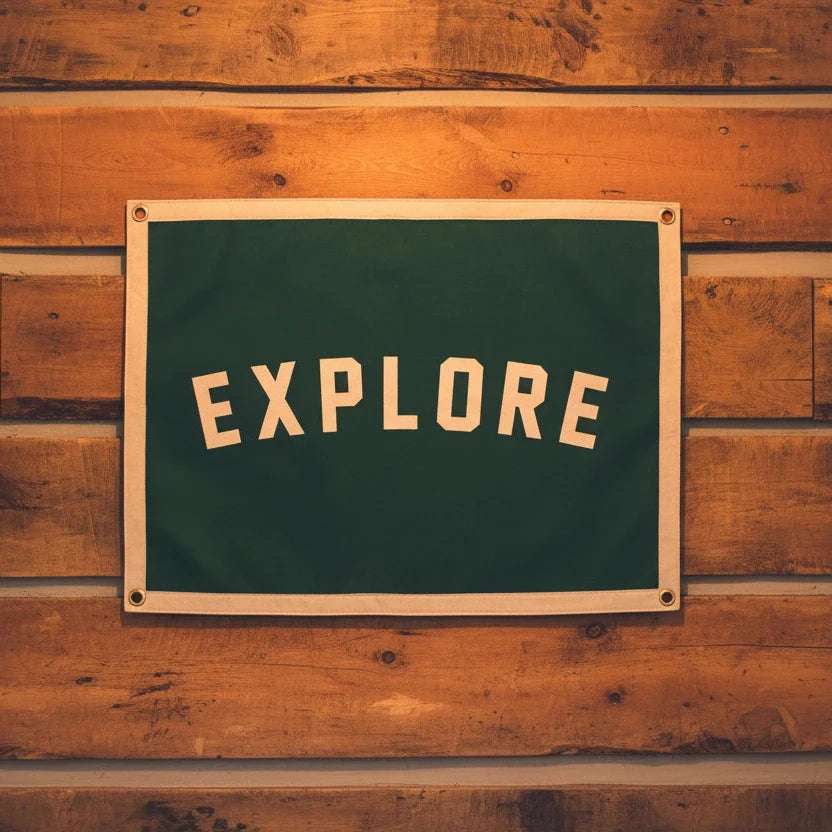 Forager Provisions LTD green wool felt banner with EXPLORE printed in white, hanging on a rustic wooden wall.