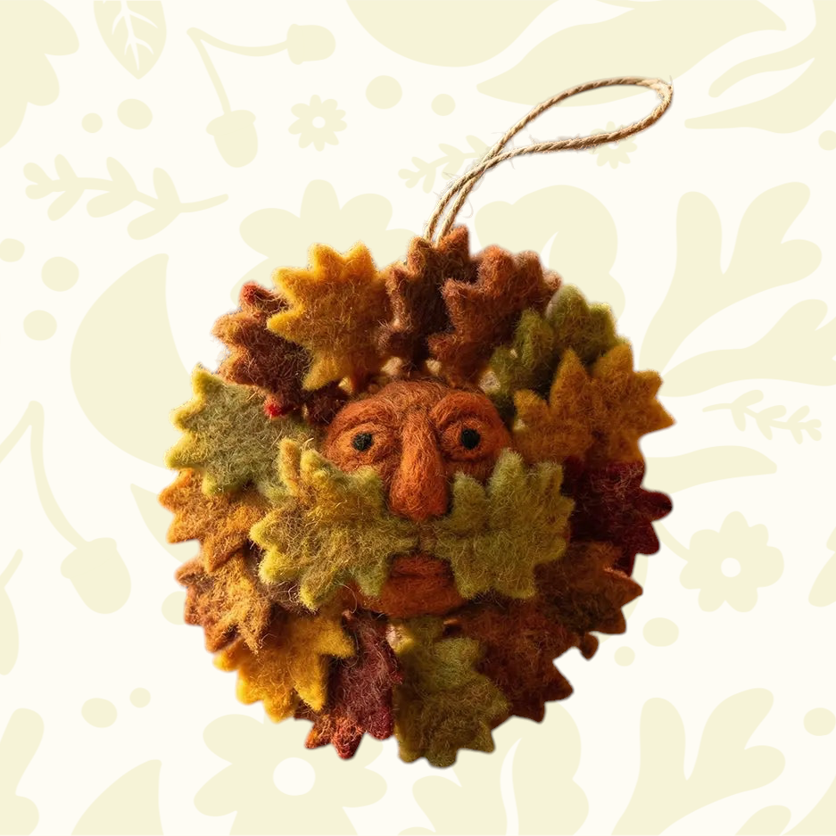 Forager Provisions LTD handcrafted felt Green Man hanging decoration with autumn leaves in shades of orange and green.