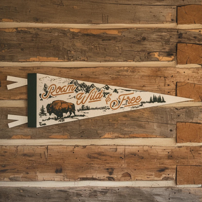 Forager Provisions LTD Benoit’s Design Co felt pennant with Roam Wild & Free bison and mountain graphic on log wall