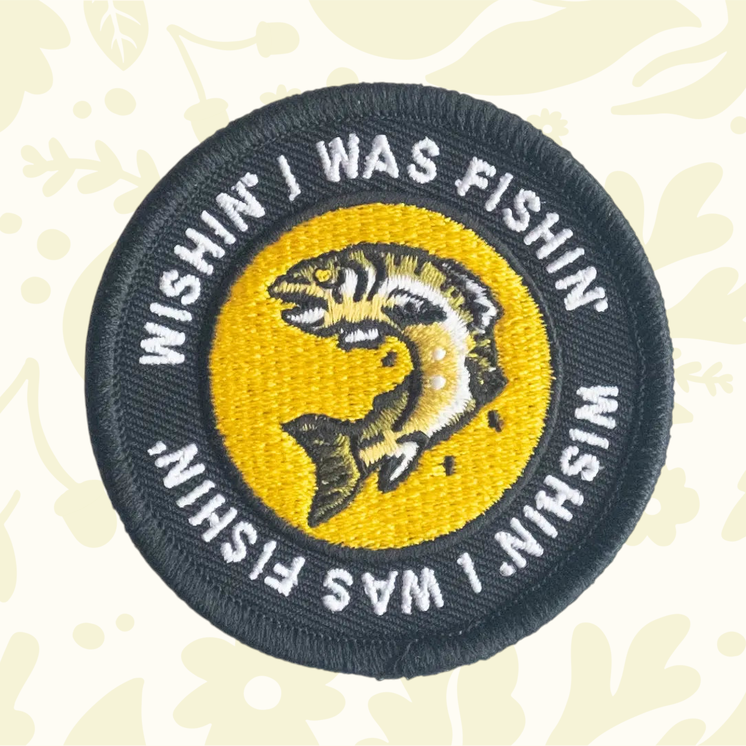 Forager Provisions LTD circular embroidered iron-on patch featuring a fish design and Wishing I Was Fishing text.