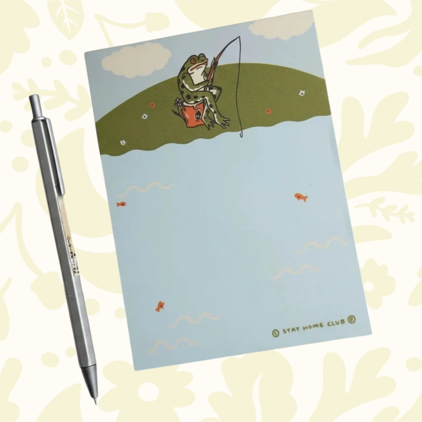 Forager Provisions LTD Stay Home Club notepad featuring a whimsical fishing frog illustration on a light blue background