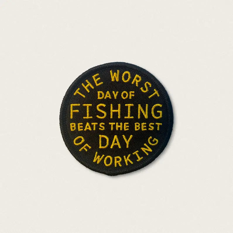Forager Provisions LTD circular embroidered patch with yellow text on black fabric reading Fishing Beats Working
