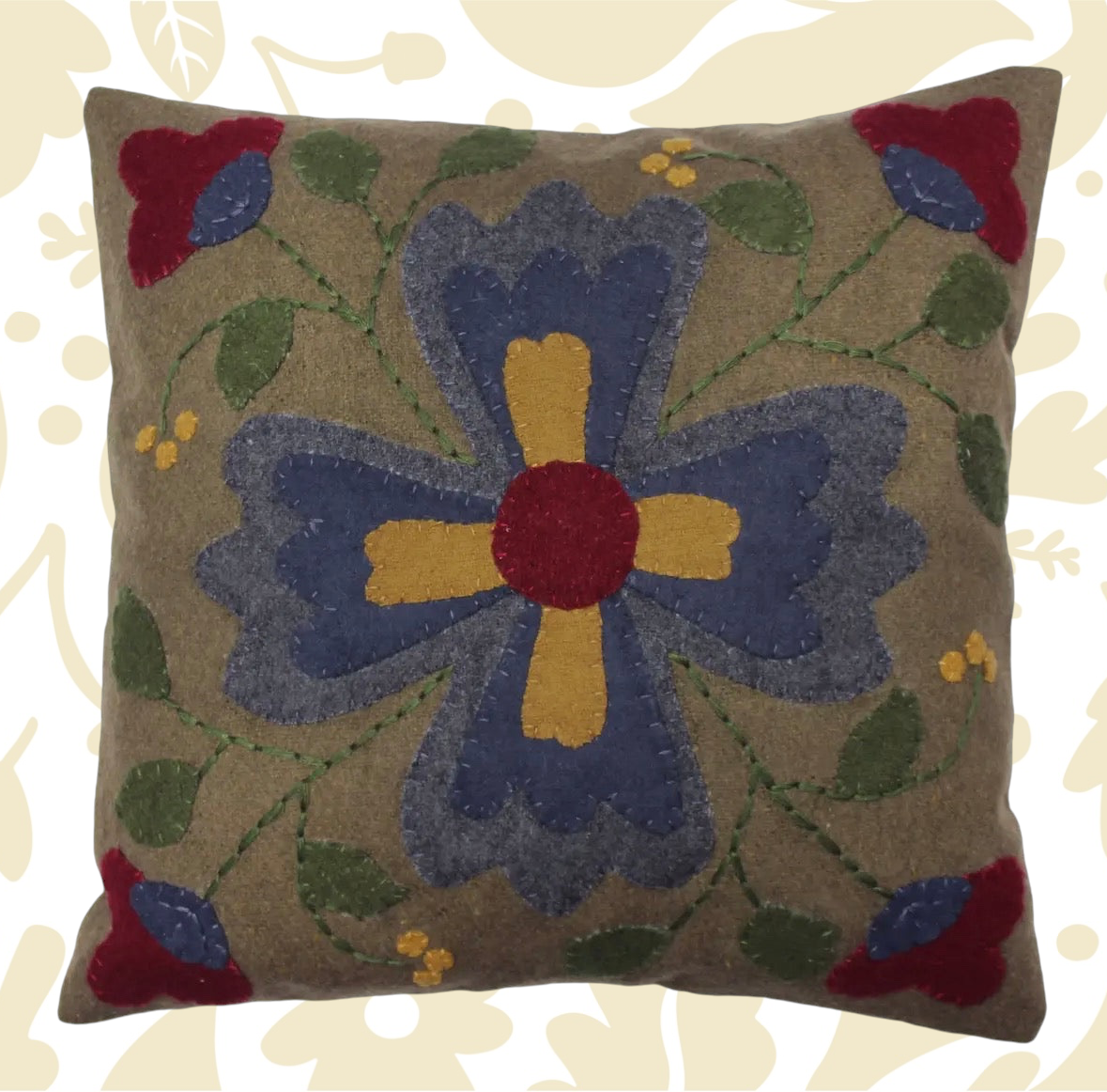 Forager Provisions LTD square wool cushion featuring a primitive folk flower motif in blue, red, and yellow tones.