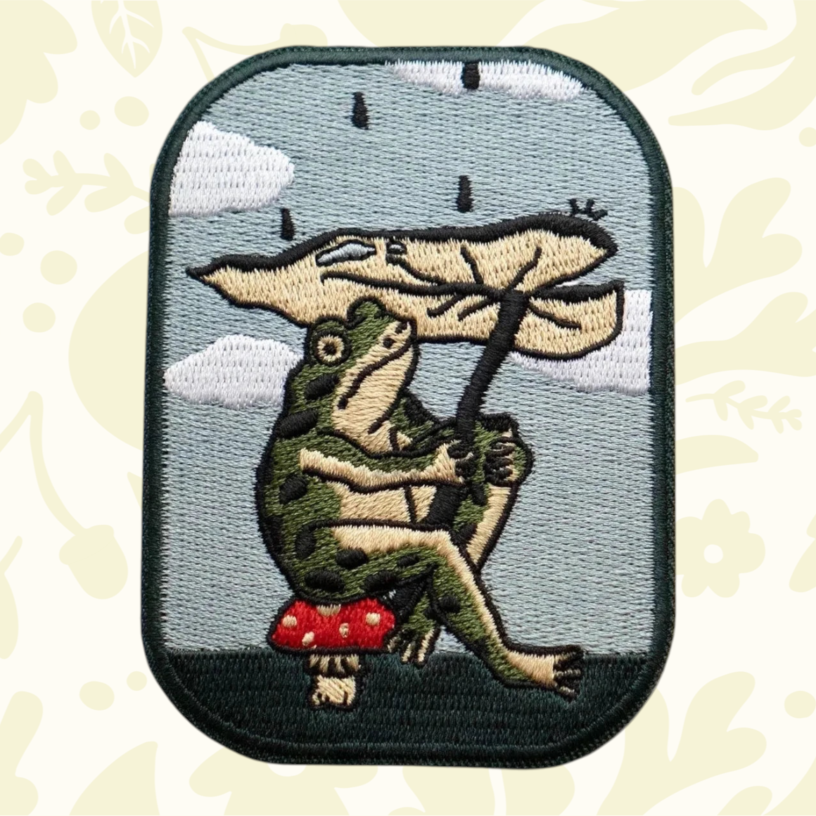 Stay Home Club’s Leaf Umbrella Frog Patch: cute frog on mushroom, peel-and-stick patch for trendy jackets, bags, and hats.