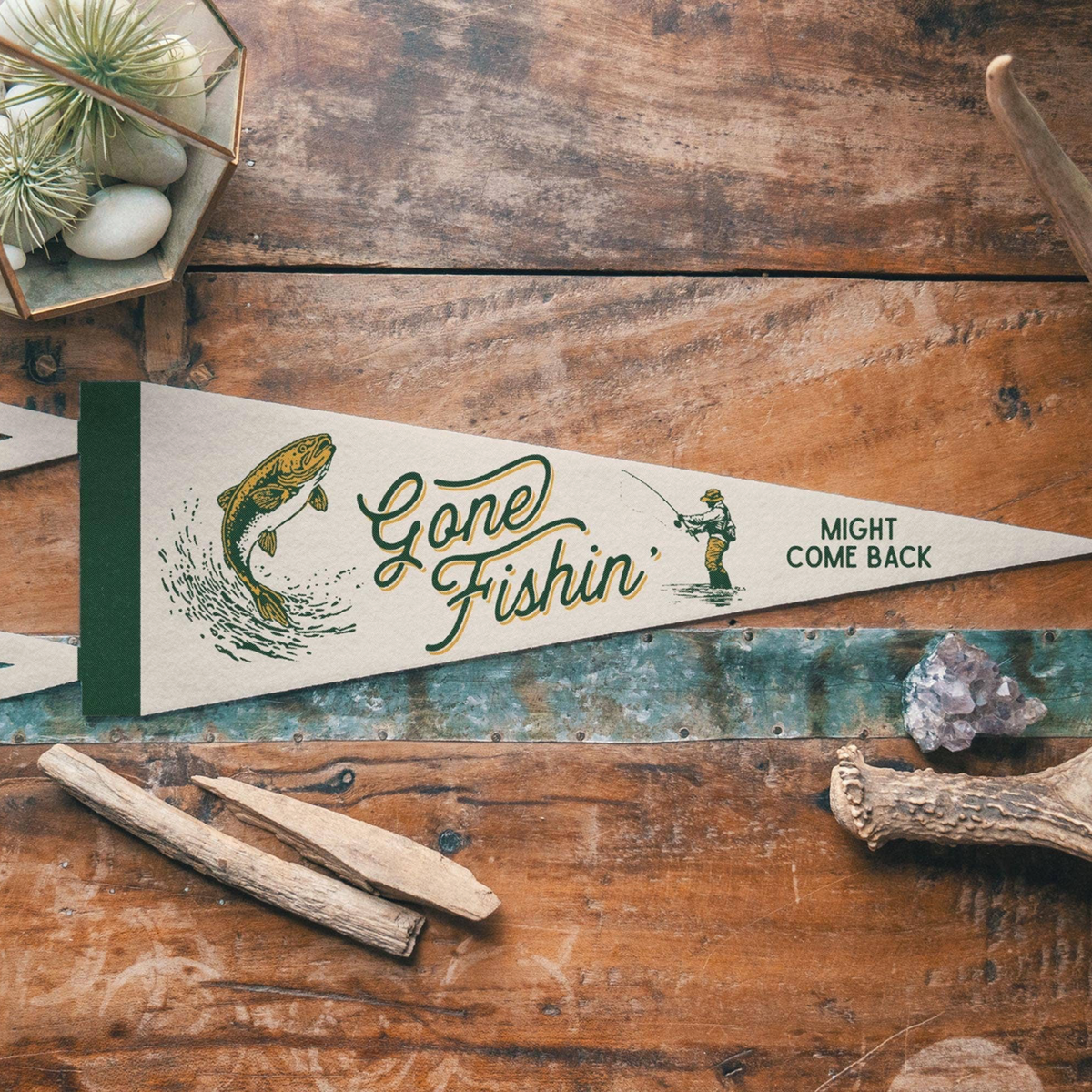 Forager Provisions LTD Benoit's Supply Co. Gone Fishin' felt pennant with vintage fishing graphics on wood table