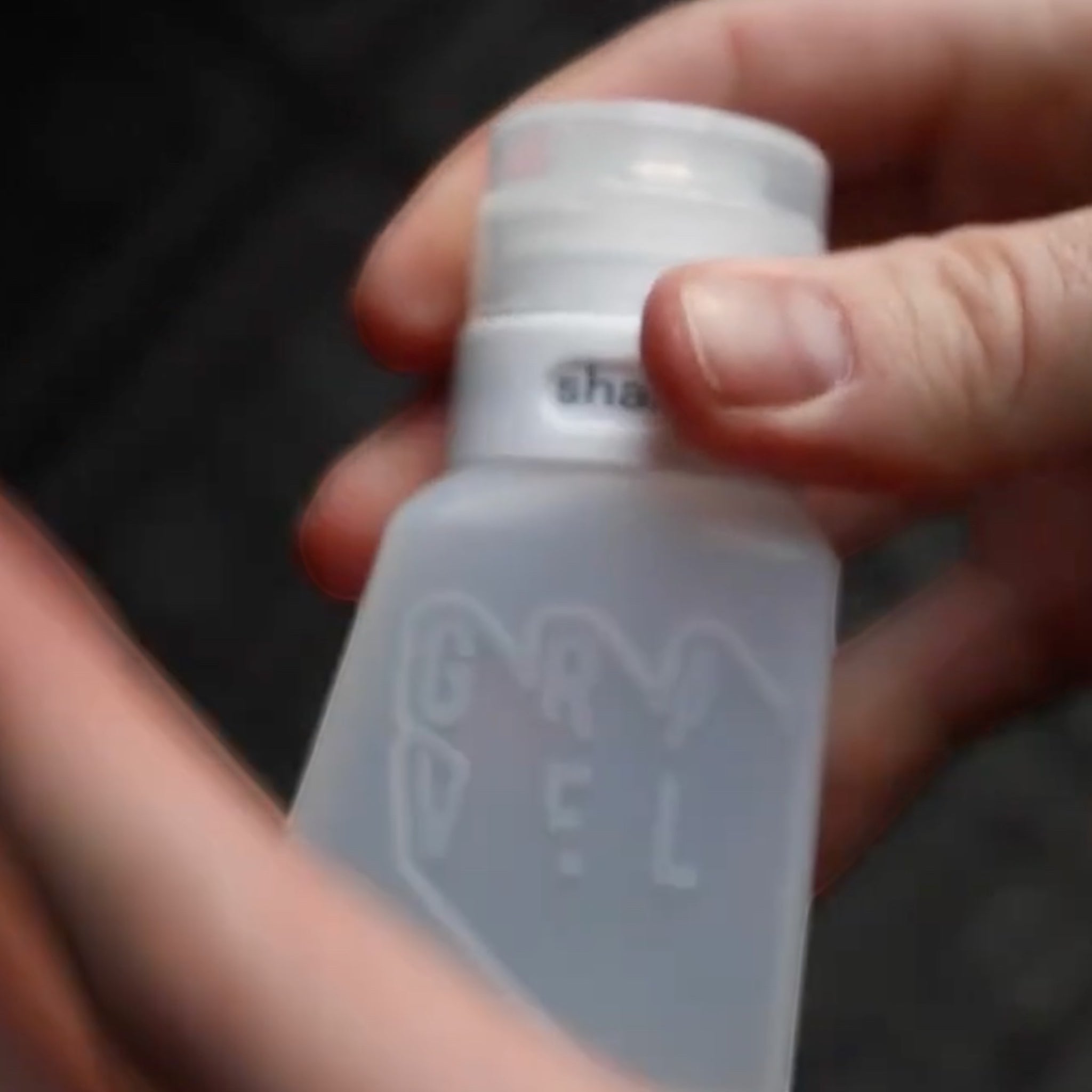 Forager Provisions LTD Gravel Outdoors refillable travel bottle in translucent white with branding and flip-top cap
