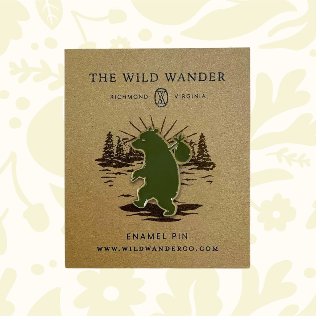 Forager Provisions LTD The Wild Wander green bear enamel pin on a branded backing card with forest illustration.