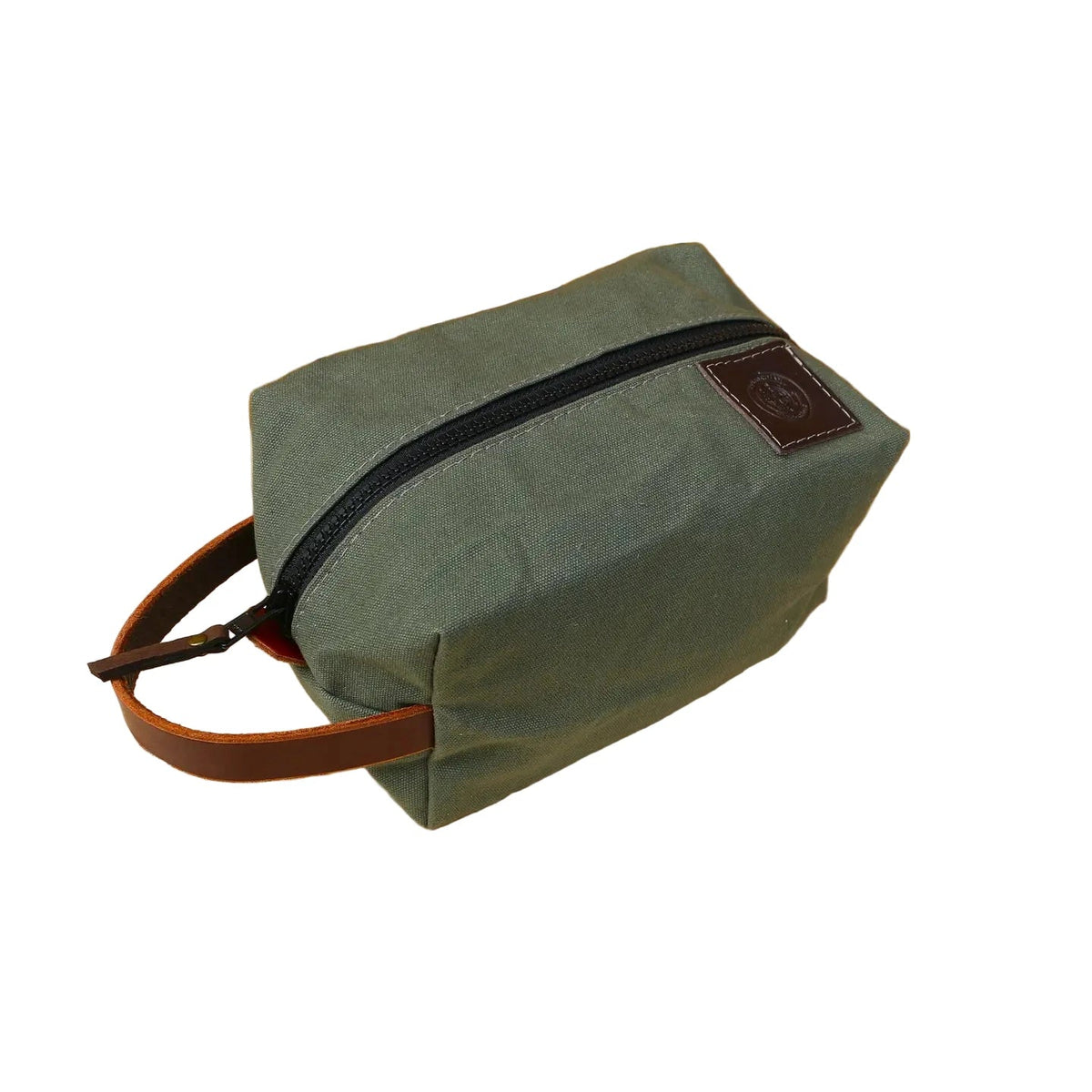 Forager Provisions LTD Journeyman Handcraft green cotton canvas toiletry bag with a brown leather handle and YKK zipper.