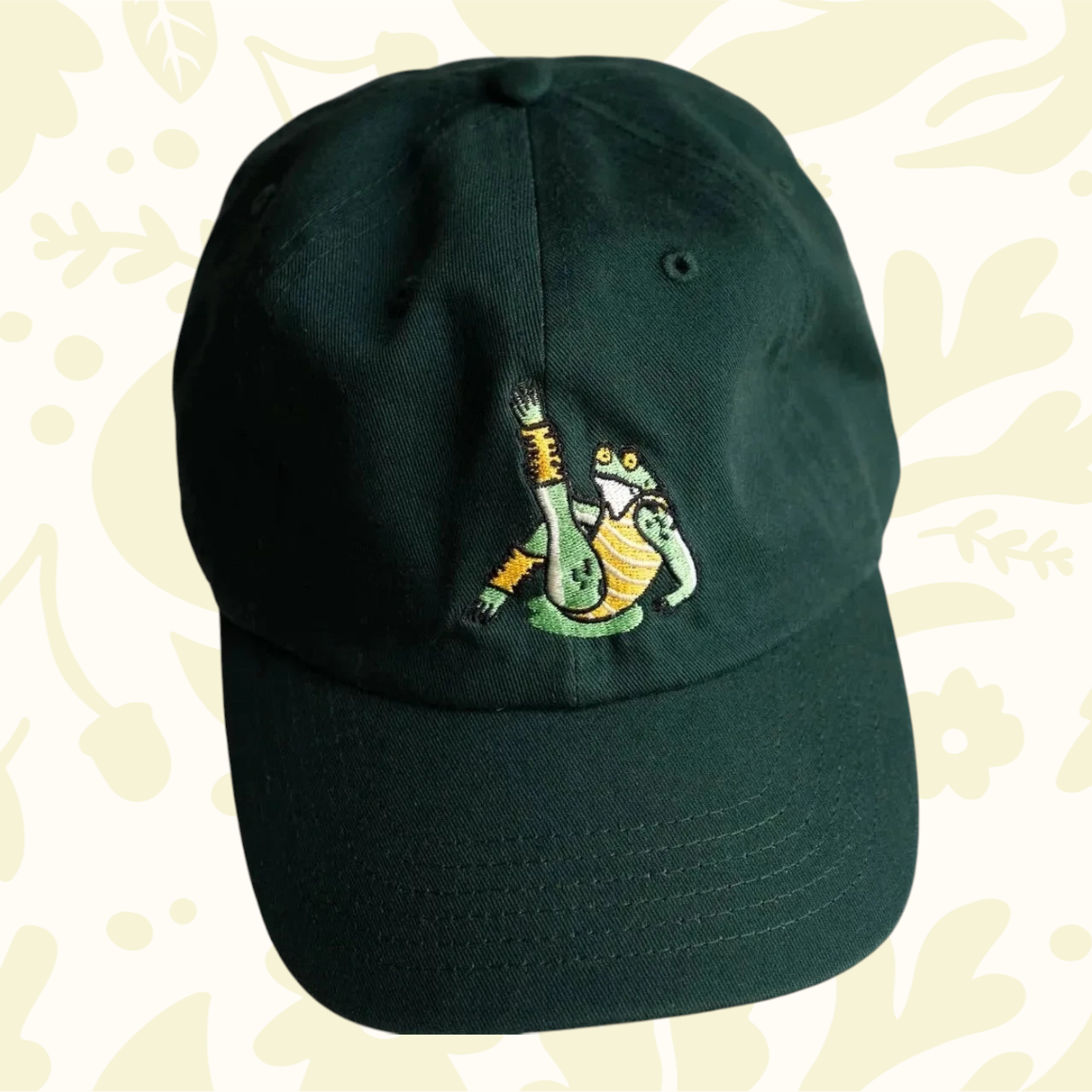 Forager Provisions LTD green cotton dad hat featuring an embroidered frog character on the front panel.