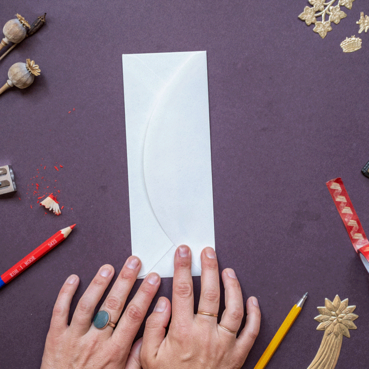 Forager Provisions LTD Hadley Christmas Elf Girl greeting card envelope on a dark purple surface with stationery items