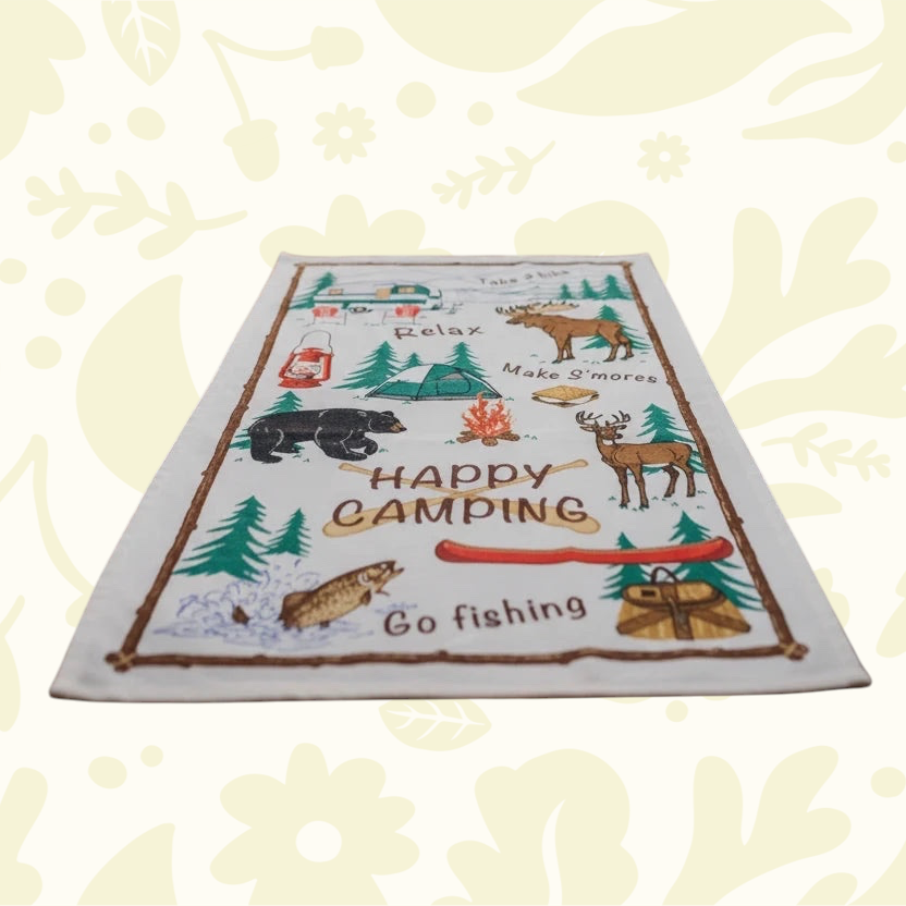Forager Provisions LTD PAINES cotton kitchen tea towel with Happy Camping outdoor woodland illustrations on a table
