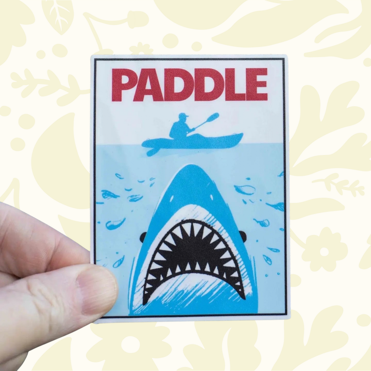 Forager Provisions LTD Hey Bear Outdoors Jaws sticker featuring a shark beneath a kayaker on a light blue background.