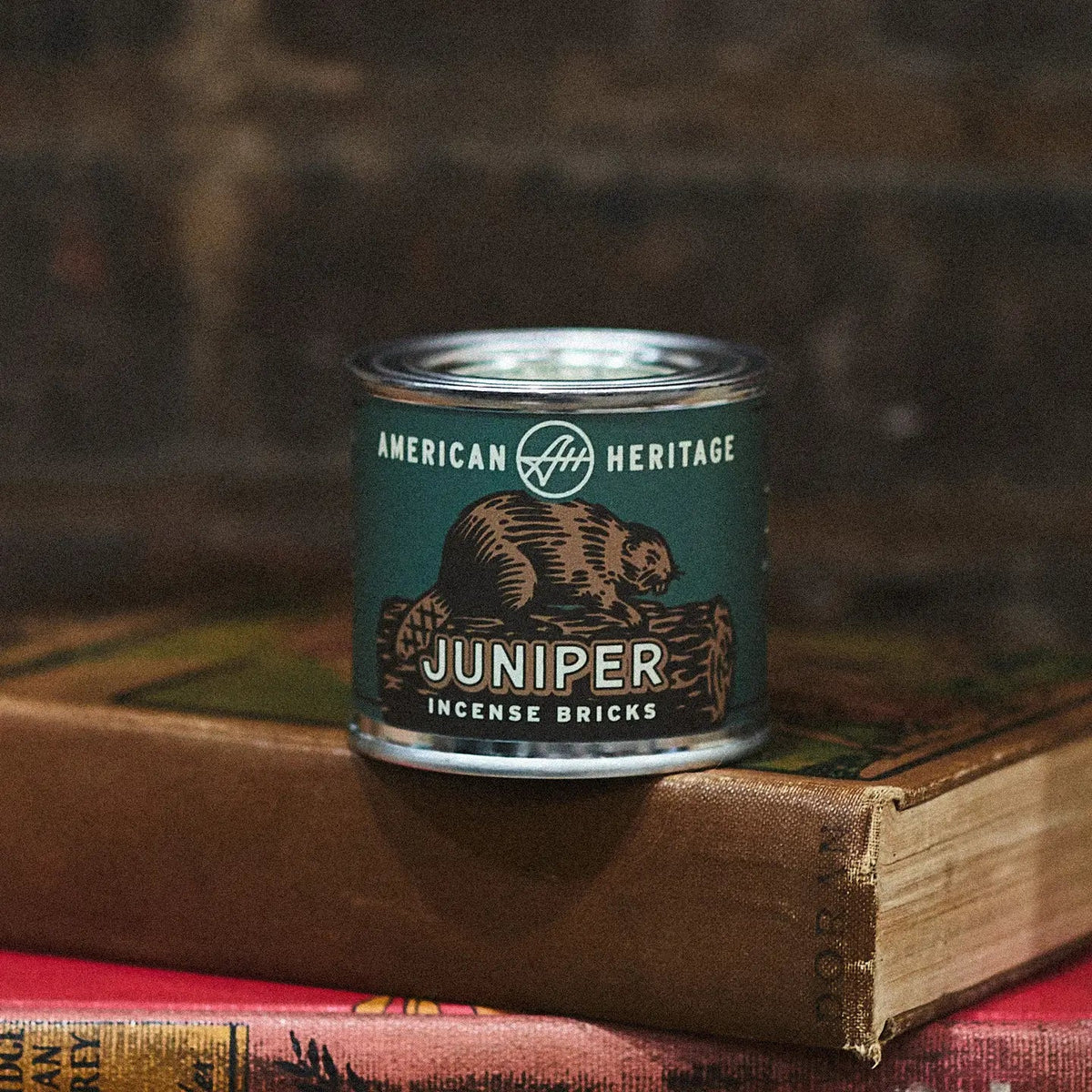 Forager Provisions LTD American Heritage Brands Juniper incense bricks in a green tin resting on vintage books.