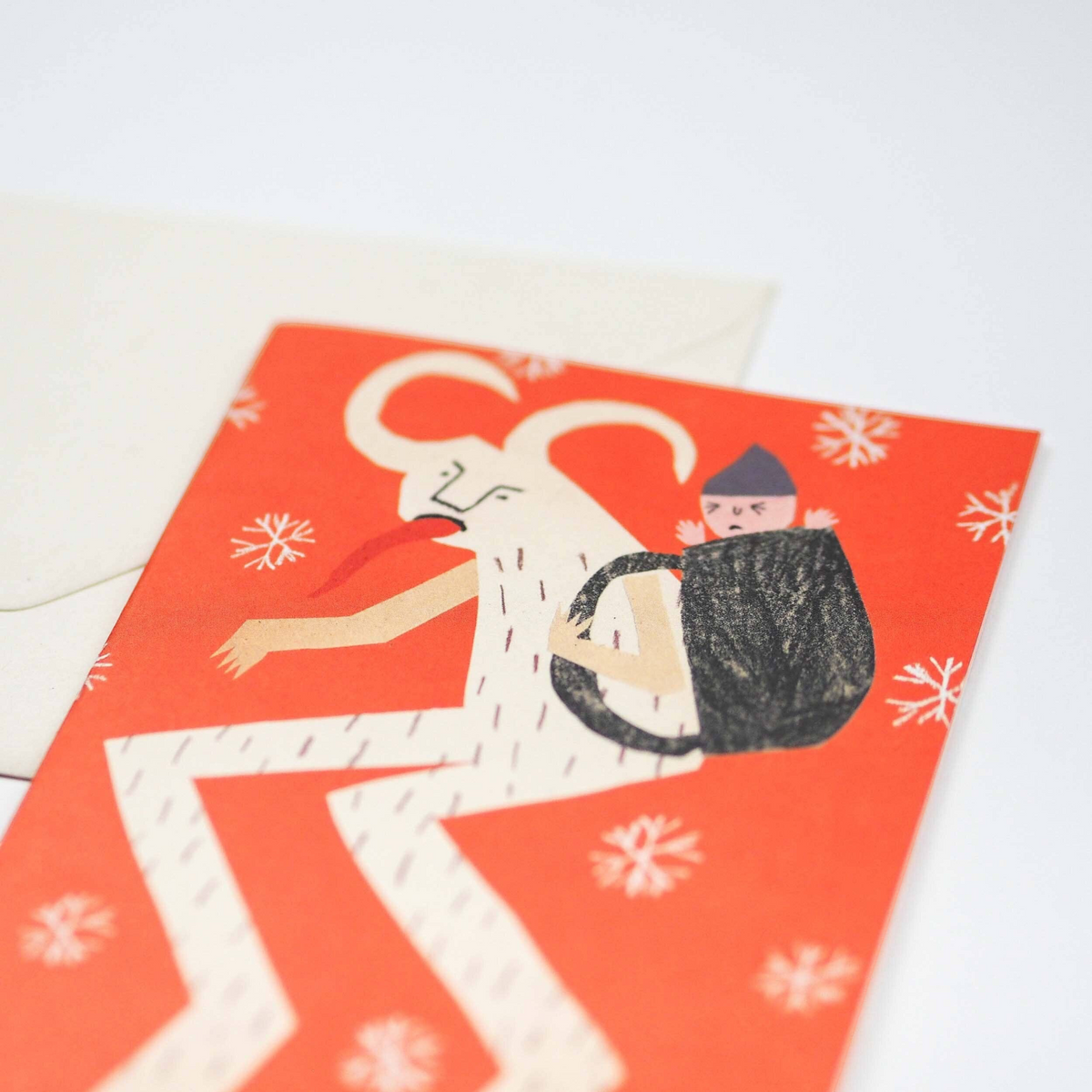 Forager Provisions LTD Krampus Christmas card featuring a red background with a horned figure carrying a child