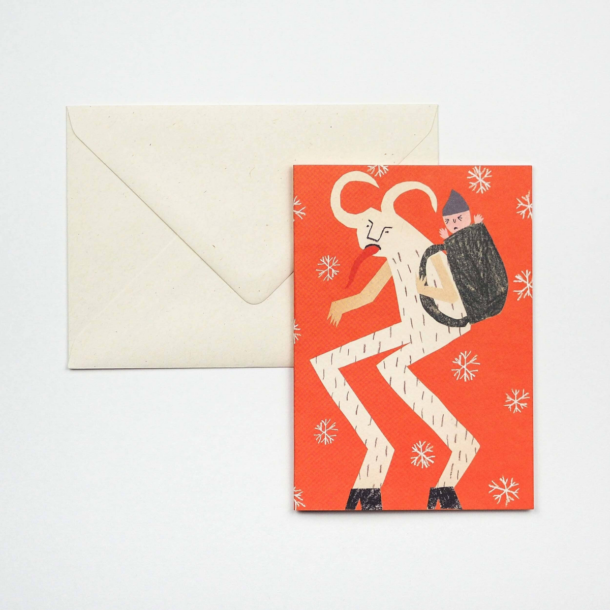 Forager Provisions LTD Krampus Christmas card with a red background and a brown envelope on a white surface.