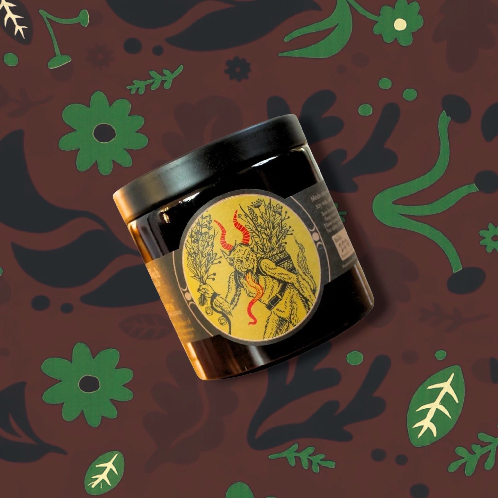 Forager Provisions LTD Sea Witch Botanicals Krampus soy wax candle in a small glass jar with a folklore illustration.