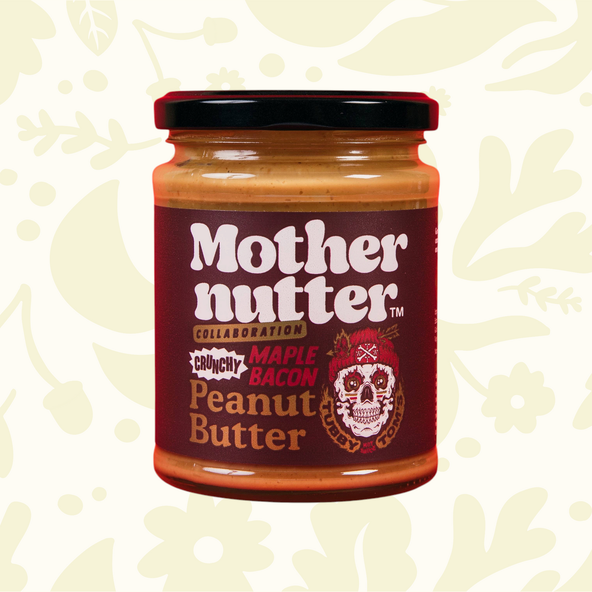 Forager Provisions LTD Mothernutter crunchy maple bacon peanut butter in a glass jar with a skull logo label.