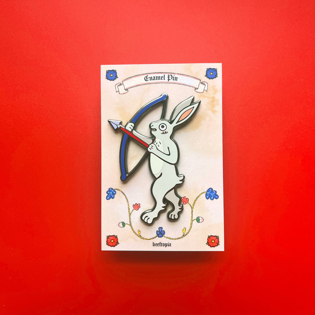 Forager Provisions LTD Beeftopia enamel pin featuring a medieval rabbit archer with a bow and arrow on a display card.