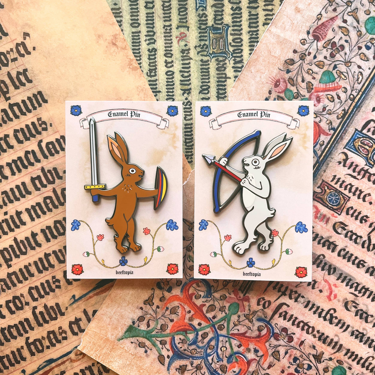 Forager Provisions LTD Beeftopia medieval rabbit enamel pins featuring a knight with sword and archer with bow