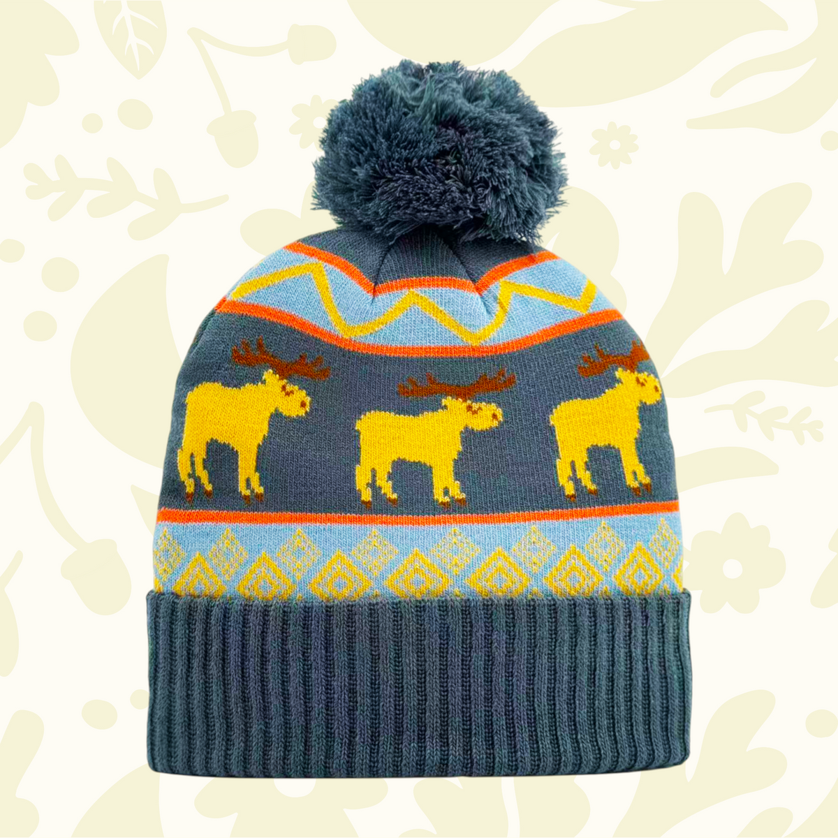 Forager Provisions LTD knit beanie featuring a yellow moose folk pattern, blue accents, and a dark grey pom pom.