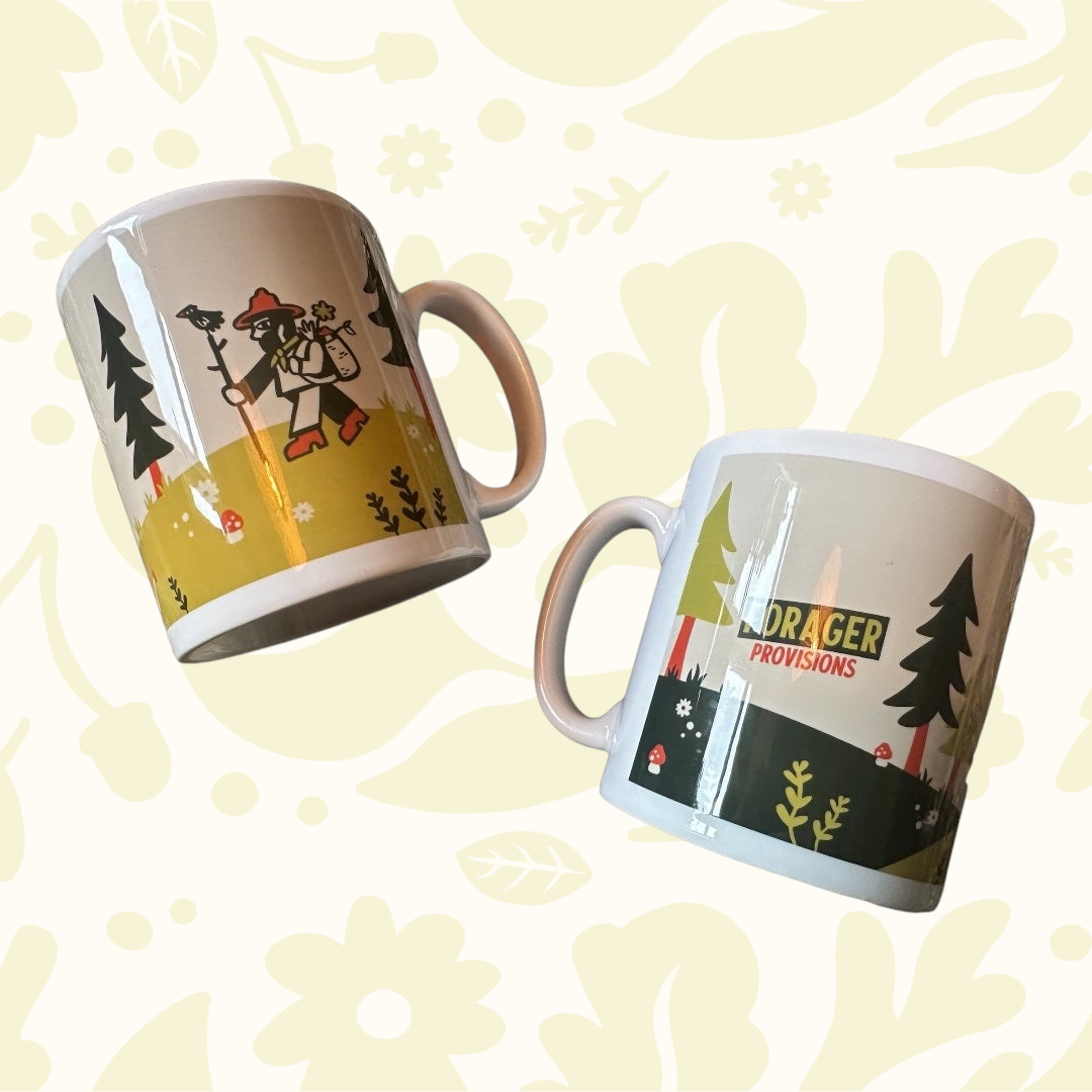 Two Forager Provisions LTD ceramic mugs featuring whimsical illustrations of a forager and his bird in a forest.