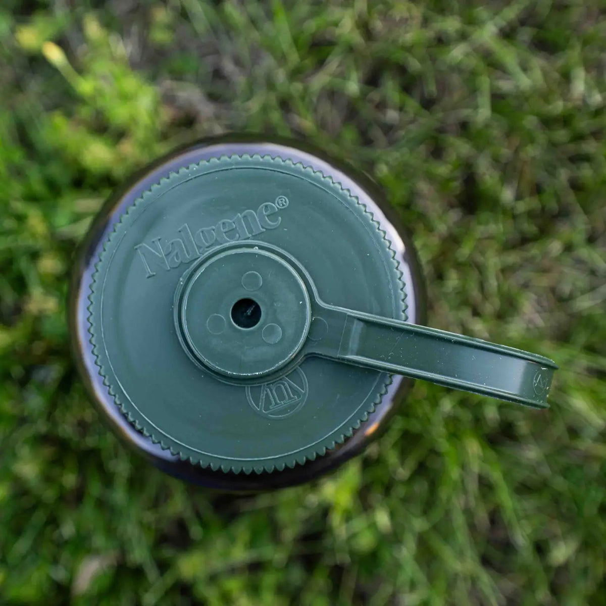 Forager Provisions LTD Hey Bear Outdoors Nalgene water bottle top view with olive green screw cap on grass
